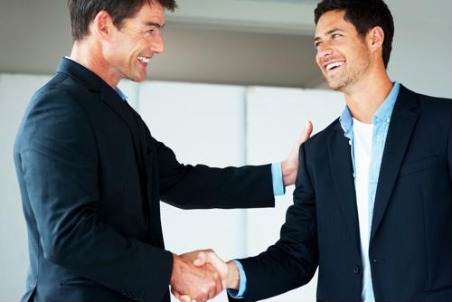 Businessmen shaking hands in an office
